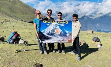 Trekkers with banner at khosar Gang Peak