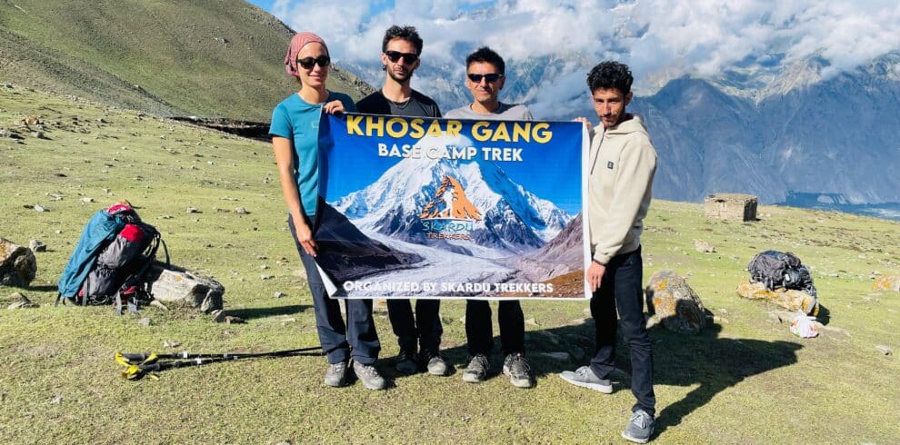 Trekkers with banner at khosar Gang Peak