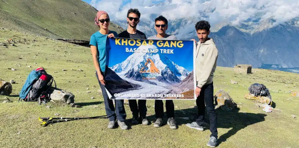 Trekkers with banner at khosar Gang Peak
