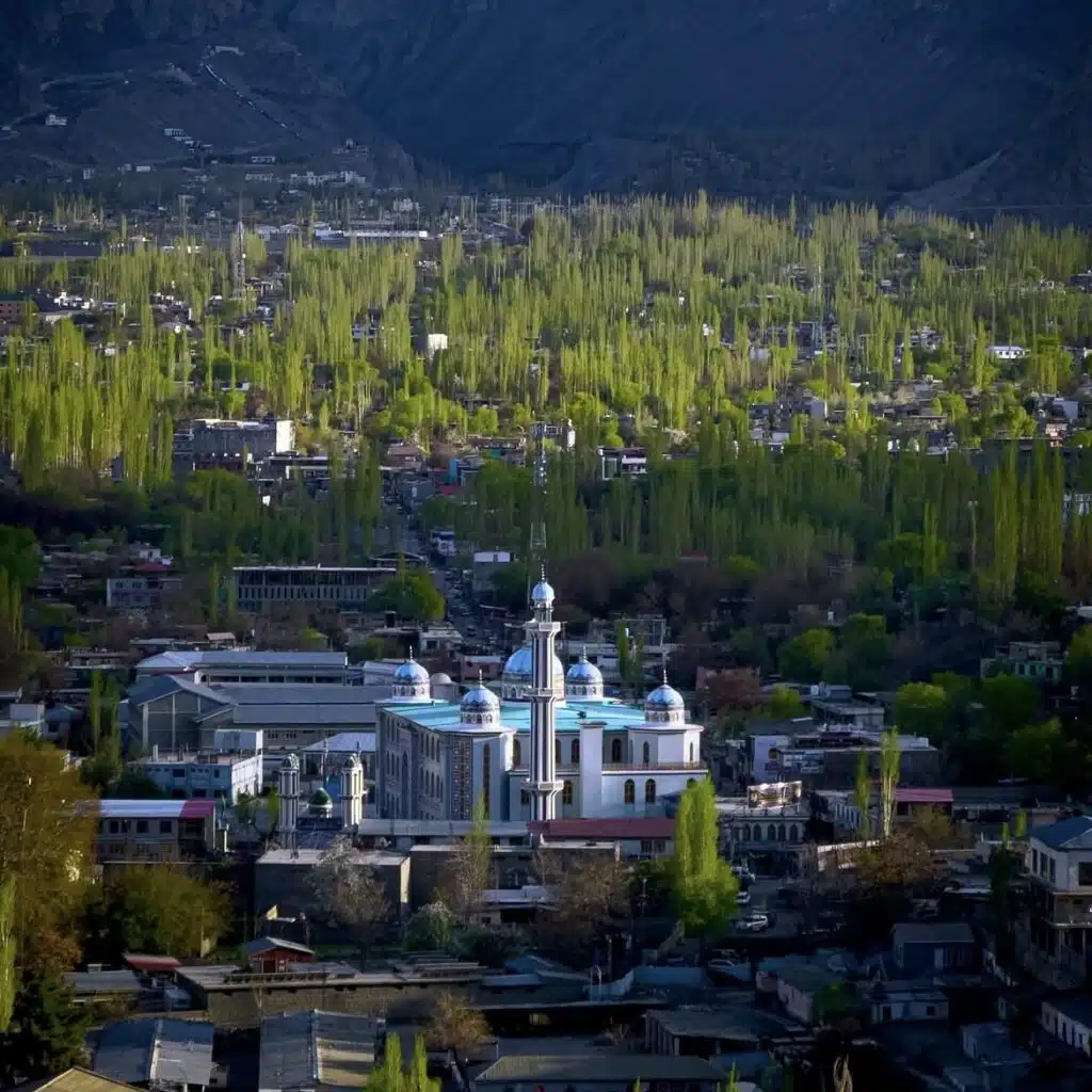 Panoramic view of Skardu city surrounded by the majestic Karakoram mountains under a clear blue sky