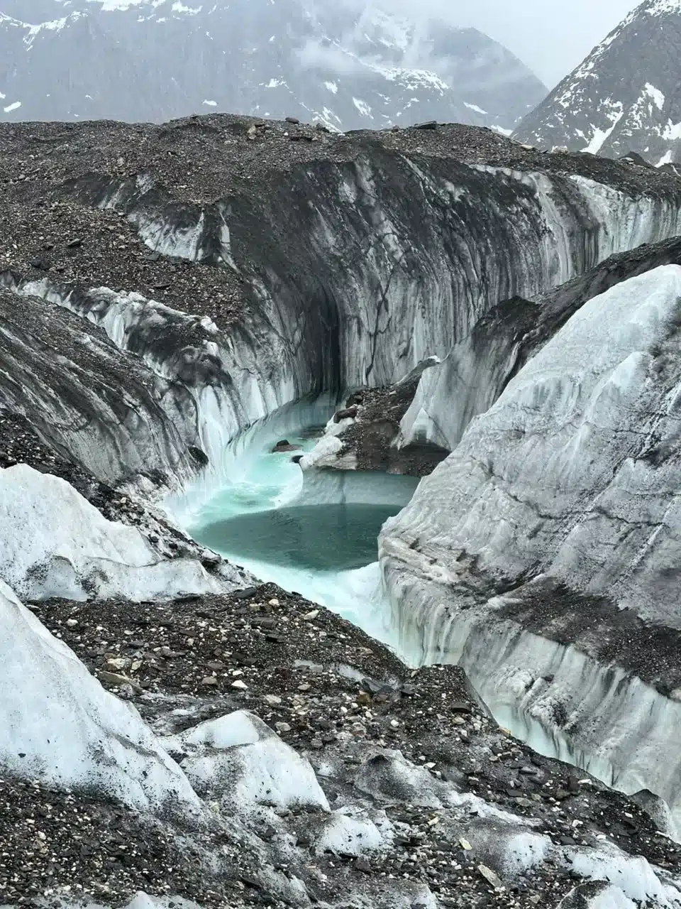 Trekkers walking across the Baltoro Glacier on the K2 Base Camp Trek.