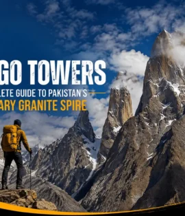Trango Towers in Pakistan’s Karakoram with a trekker overlooking the dramatic granite peaks